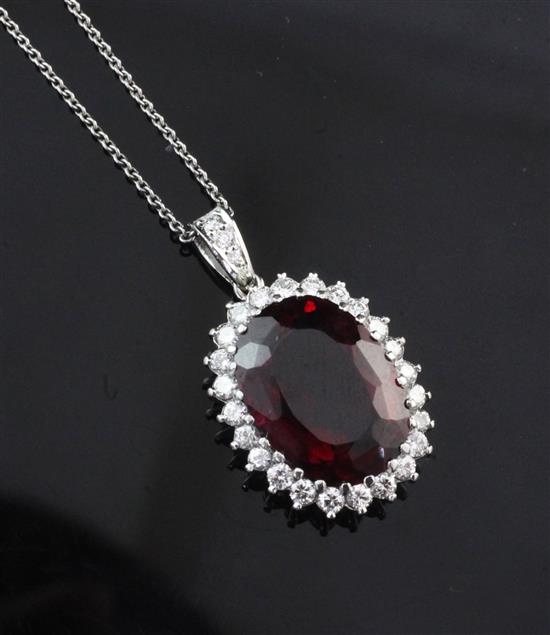 A white gold, red tourmaline and diamond set pendant on white metal chain, pendant 1in inc. bale.